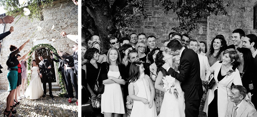 groom kissing the bride during family picture