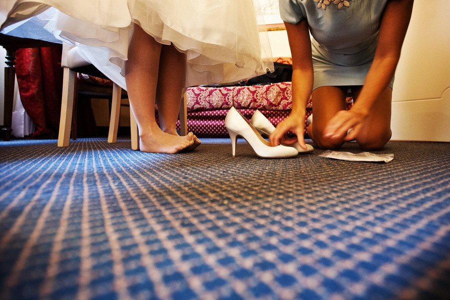 bride gets on her shoes, playing with her feets
