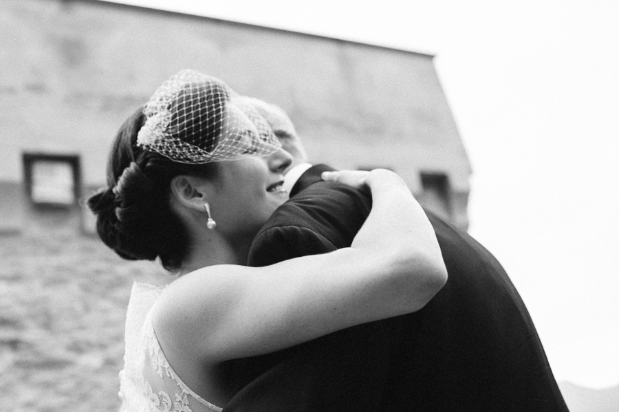 bride hugging her dad during beautiful destination wedding on the sea in italy