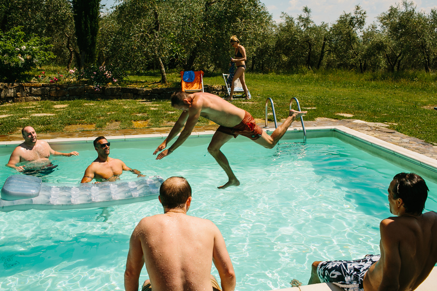 Wedding guess jump in the pool at castello del trebbio tuscany