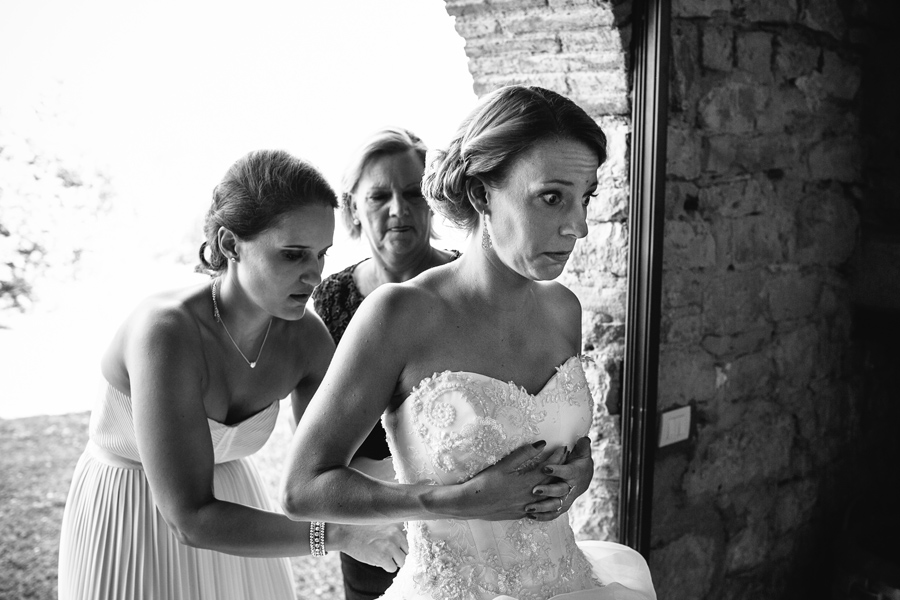 bride getting ready and helped by her friends