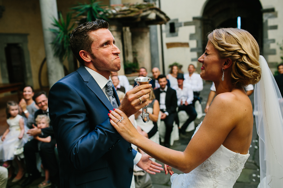 Groom having a drink during wedding ceremony