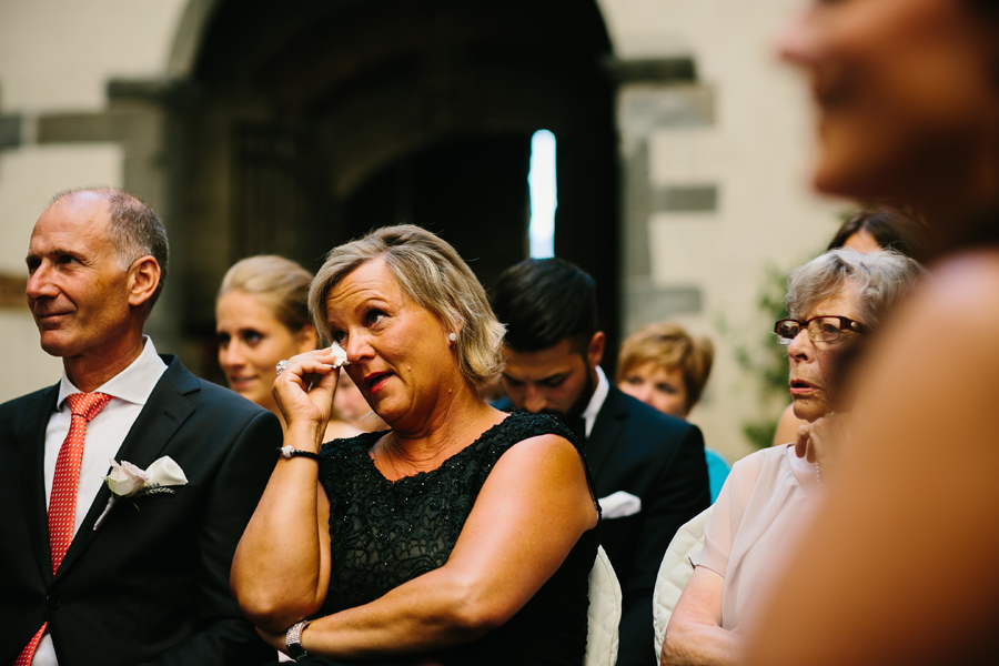 Mother of the groom crying with tears during ceremony in tuscany