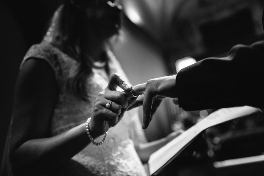 ring exchange during catholic wedding ceremony in tuscany