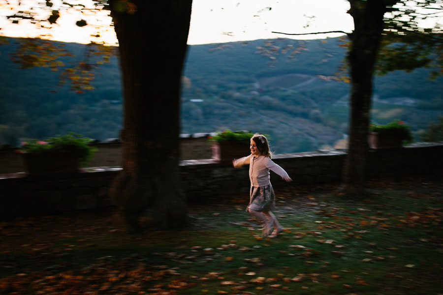 little girl running during wedding in tuscany