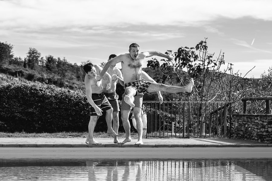 Castello di Meleto Wedding Groom jumping in swimming pool