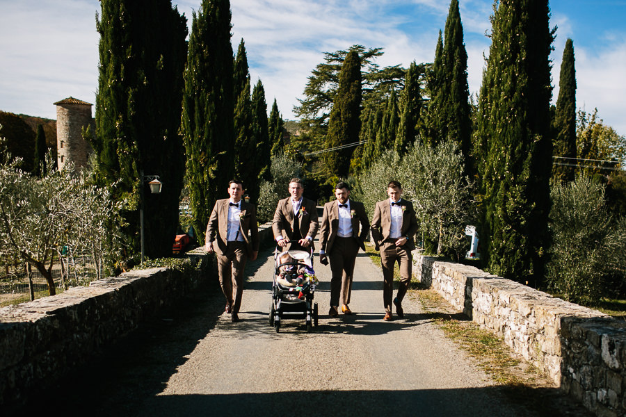 groom and groomsmen walking up to wedding ceremony at castello di meleto