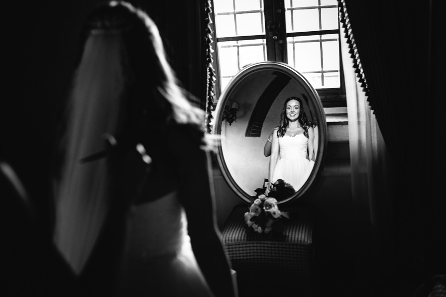 Bride in front of a mirror at Castello di Spaltenna Wedding