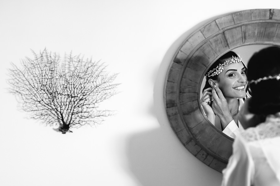 bride putting on her earrings at ostuni Wedding Photographer