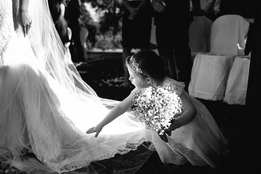 little girl touching wedding dress