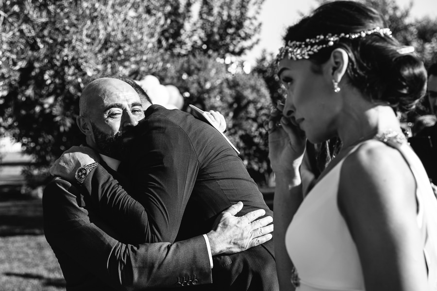 father of the bride hugging groom at puglia wedding