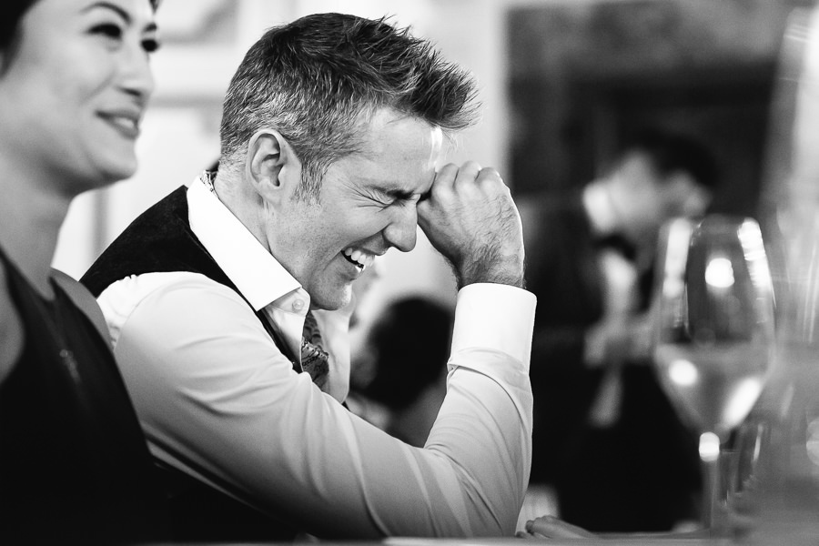 groom laughing at wedding