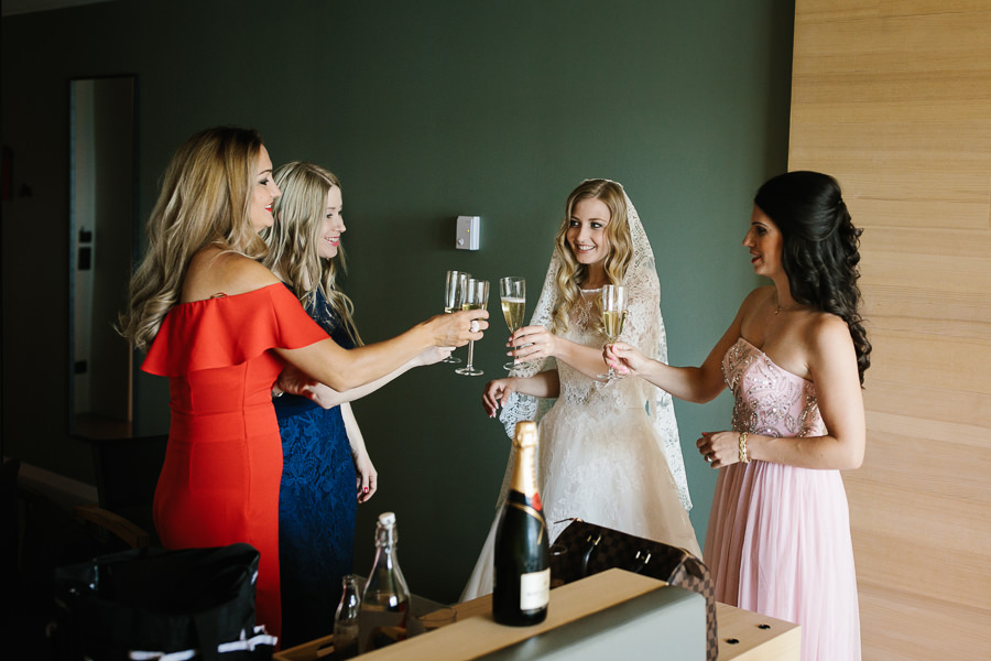 Bride and Bridesmaid drinking champagner before wedding in meran