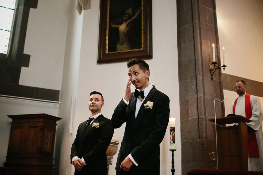 groom simon waiting in church for his bride