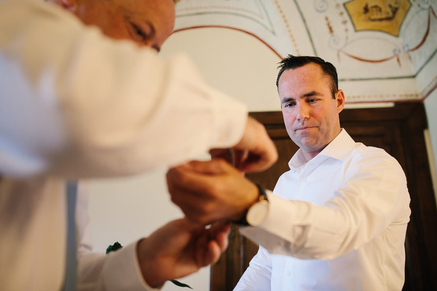 groom putting on his cufflings