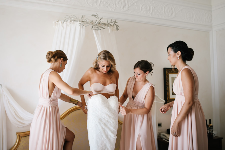 bride putting on her dress