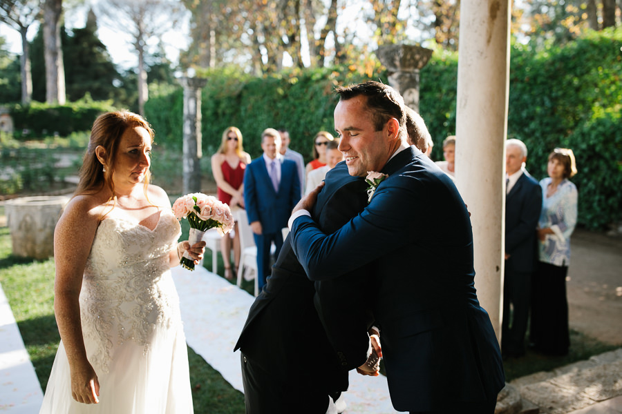 groom and bride’s brother hugging