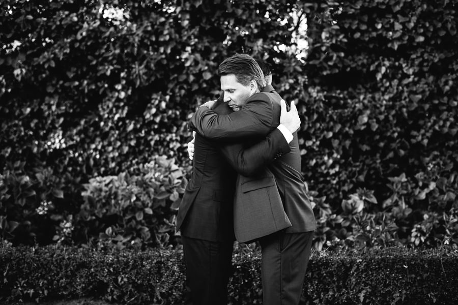 groom hugging a guest