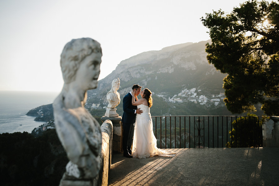 bride and groom wedding portrait Villa Cimbrone next to a statue in the garden