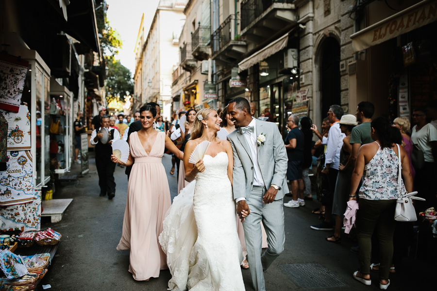 nazanin and sirak walking through the streets of taormina