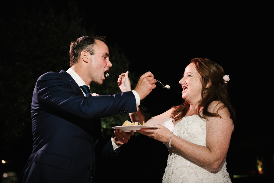 cake eating bride and groom