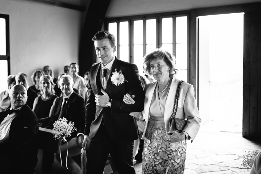 Groom and his mother entering wedding ceremony venue