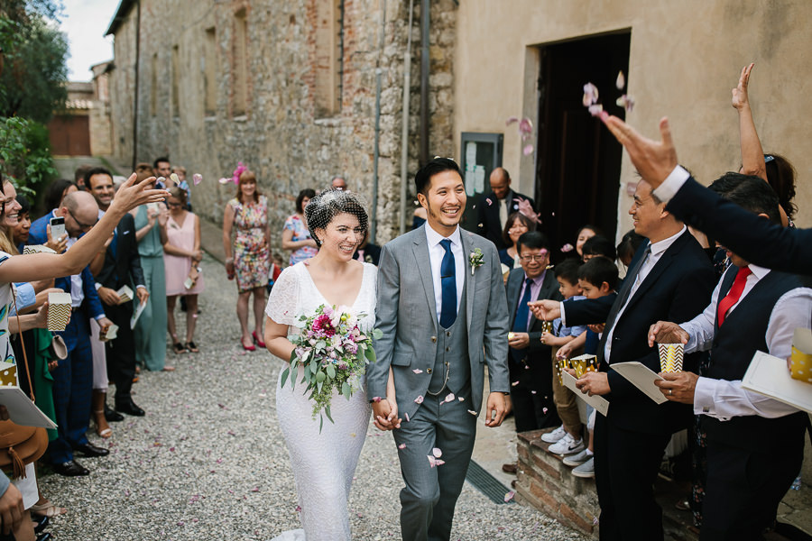 Wedding couple leaving church in Tuscany