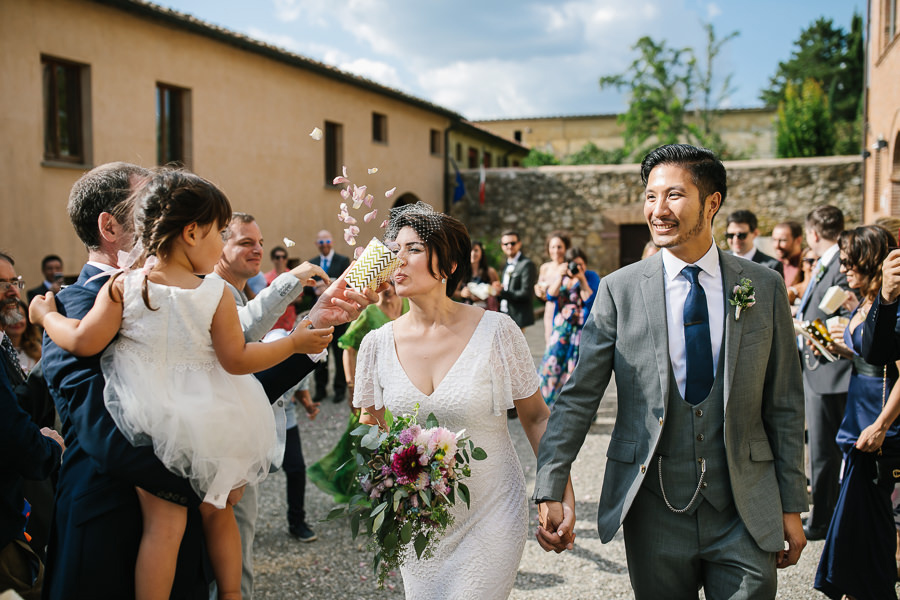 Wedding couple leaving church in Tuscany