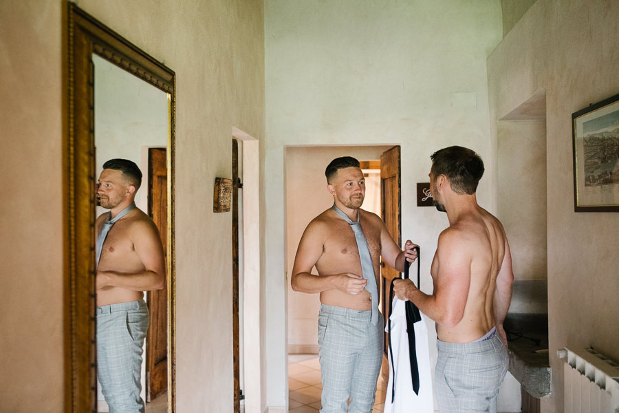 Groom getting ready for wedding at Castello del Trebbio