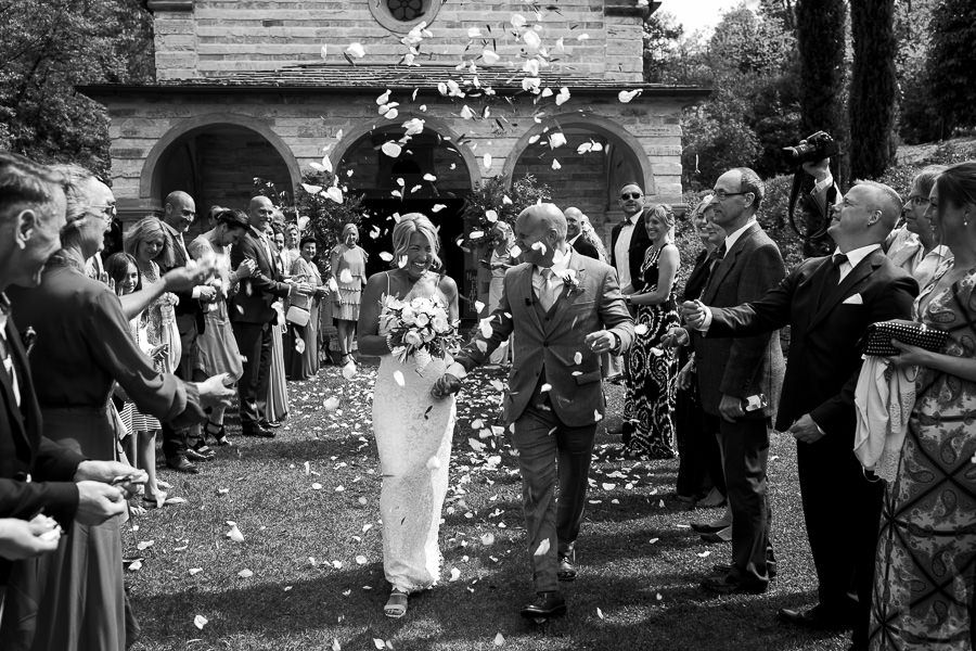 Bride and groom leaving wedding church in Tuscany