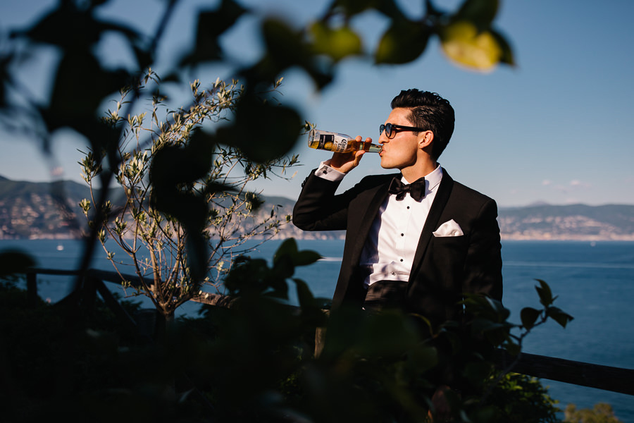 Groom drinking beer in Portofino