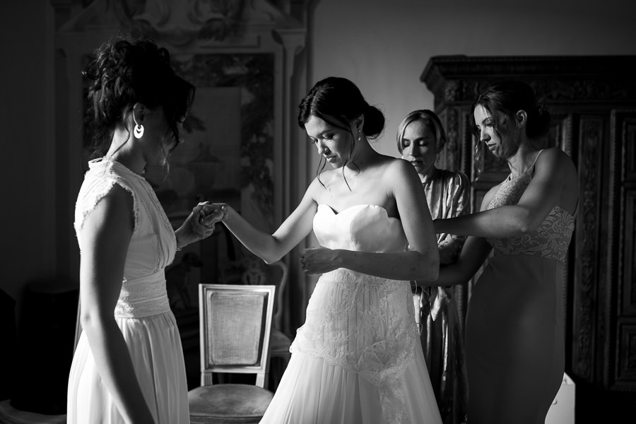 Bride putting on her dress at Castello di Meleto