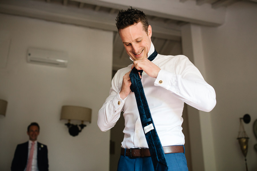 Groom and his best mean getting ready for wedding in tuscany