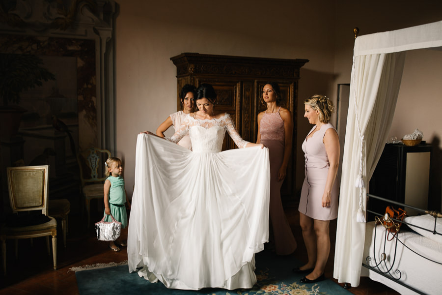 Bride putting on her dress at Castello di Meleto