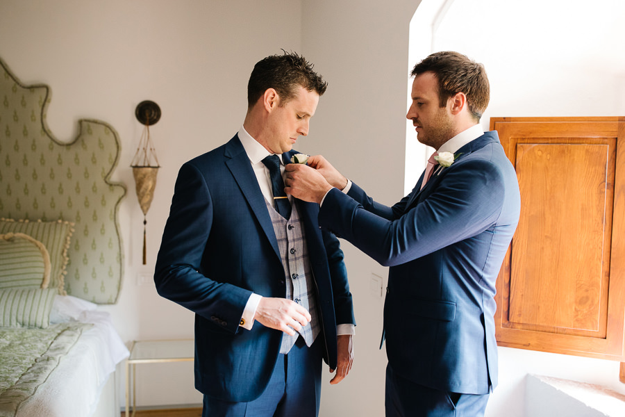 Groom and his best mean getting ready for wedding in tuscany