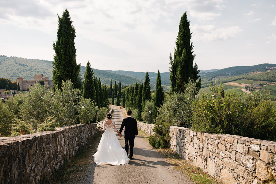 bride and groom walking down the aisle to castello di meleto