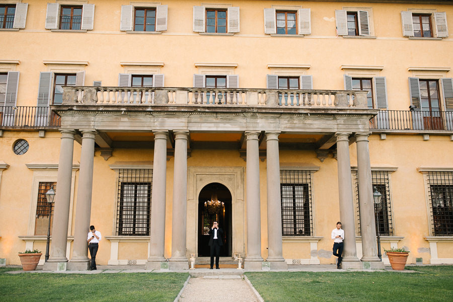 bride and groom walking together through the garden in fiesole