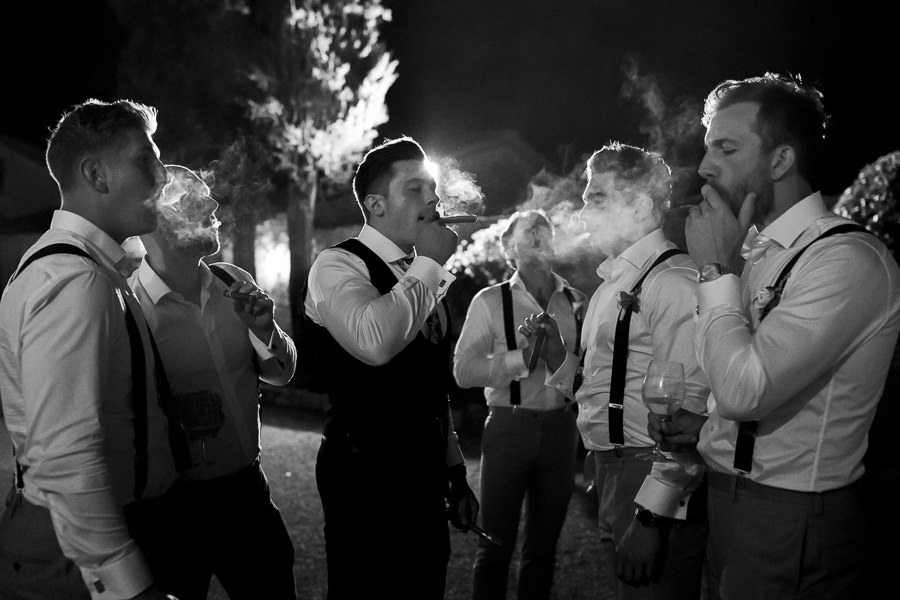 groom and groomsmen with cigars